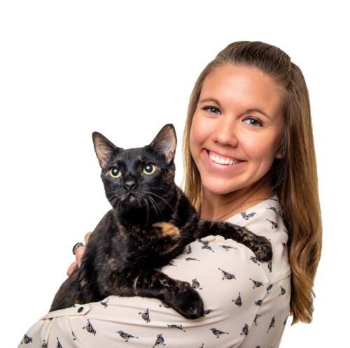 Veterinary practice owner Jenn Galvin holds a black cat