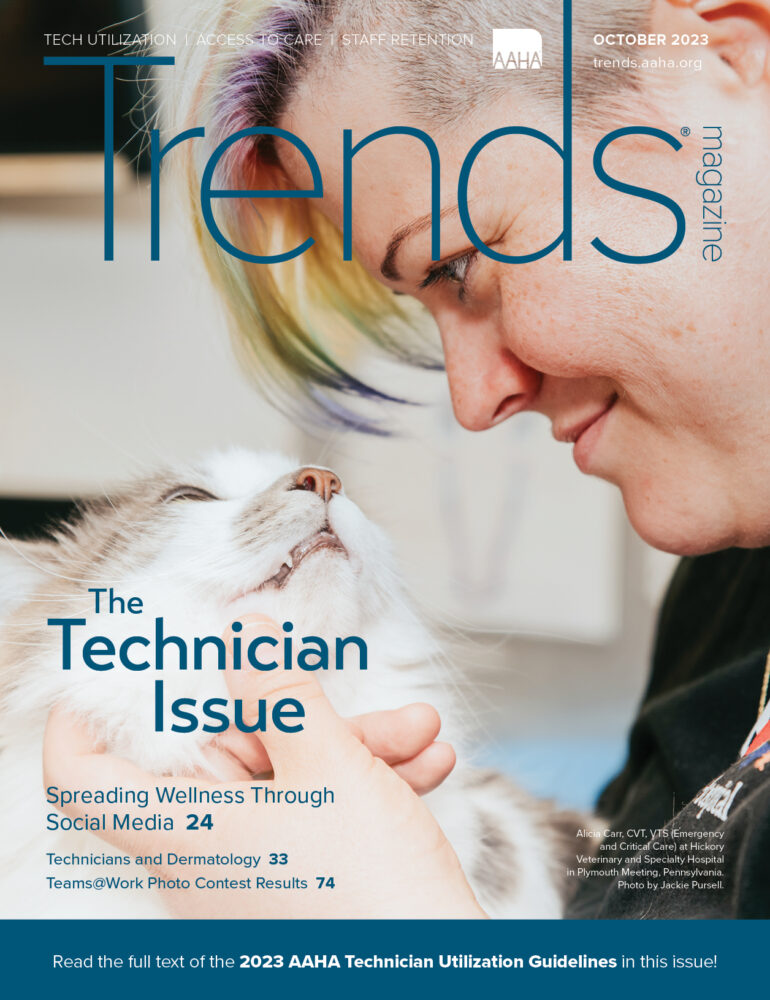 Cover of October 2023 Trends—Photo of Alicia Carr, CVT, VTS (Emergency and Critical Care) petting a cat