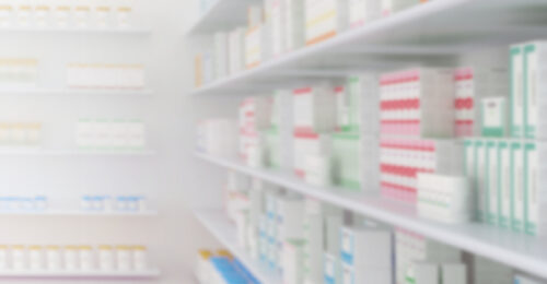 A blurred image of a stock room filled with shelves of inventory