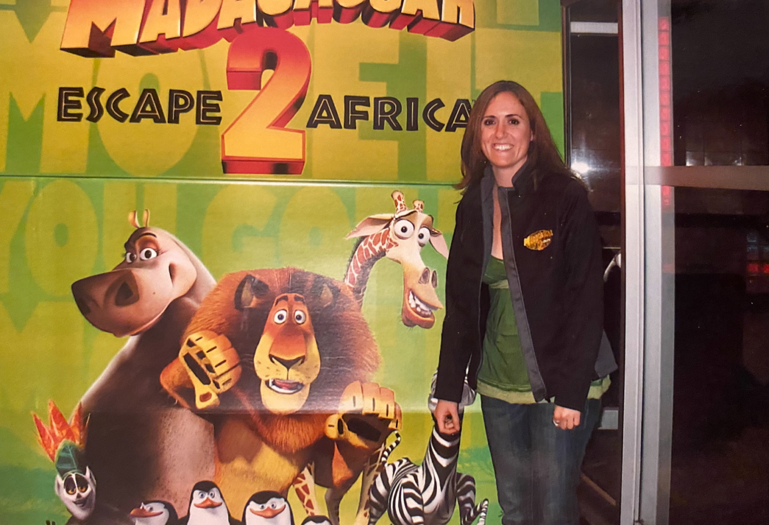 dr. andrea spediacci when she worked at dreamworks, standing in front of a movie poster