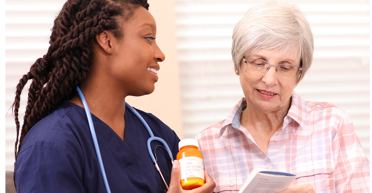 Technician going over pet's medication with her client after a dermatology appointment.