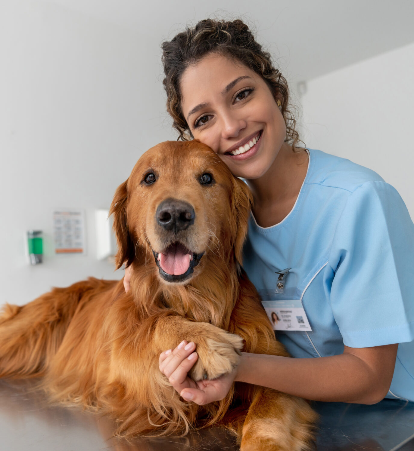 Portrait of a happy veterinarian with a dog at the clinic