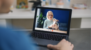 Computer screen showing woman and dog