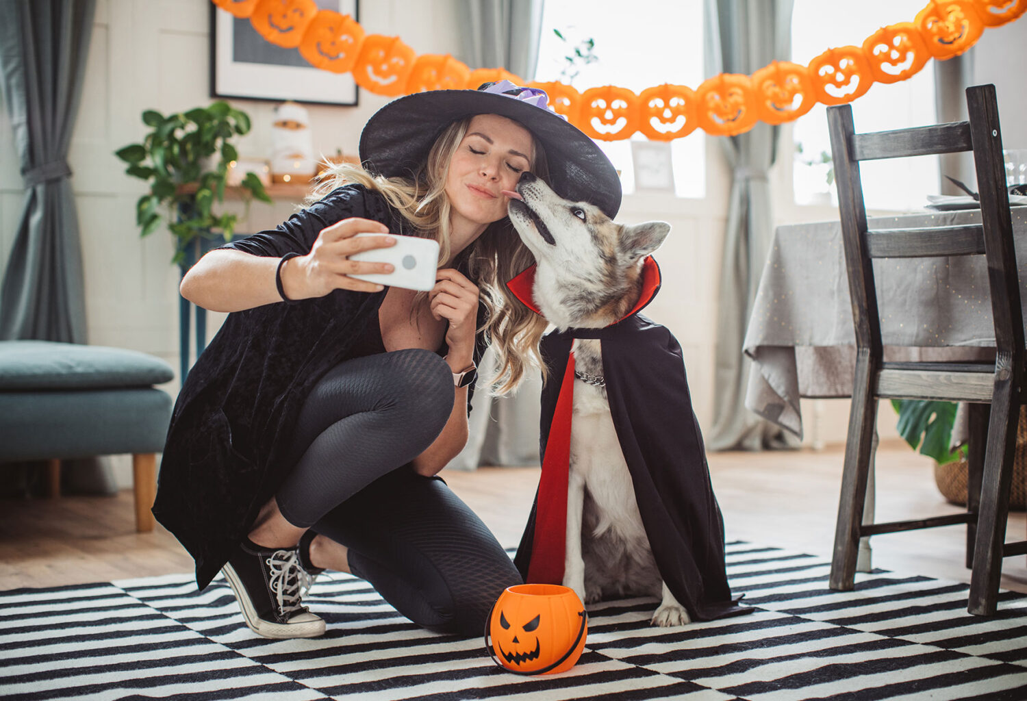 Dog and owner in costumes taking pictures