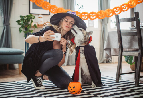 Dog and owner in costumes taking pictures